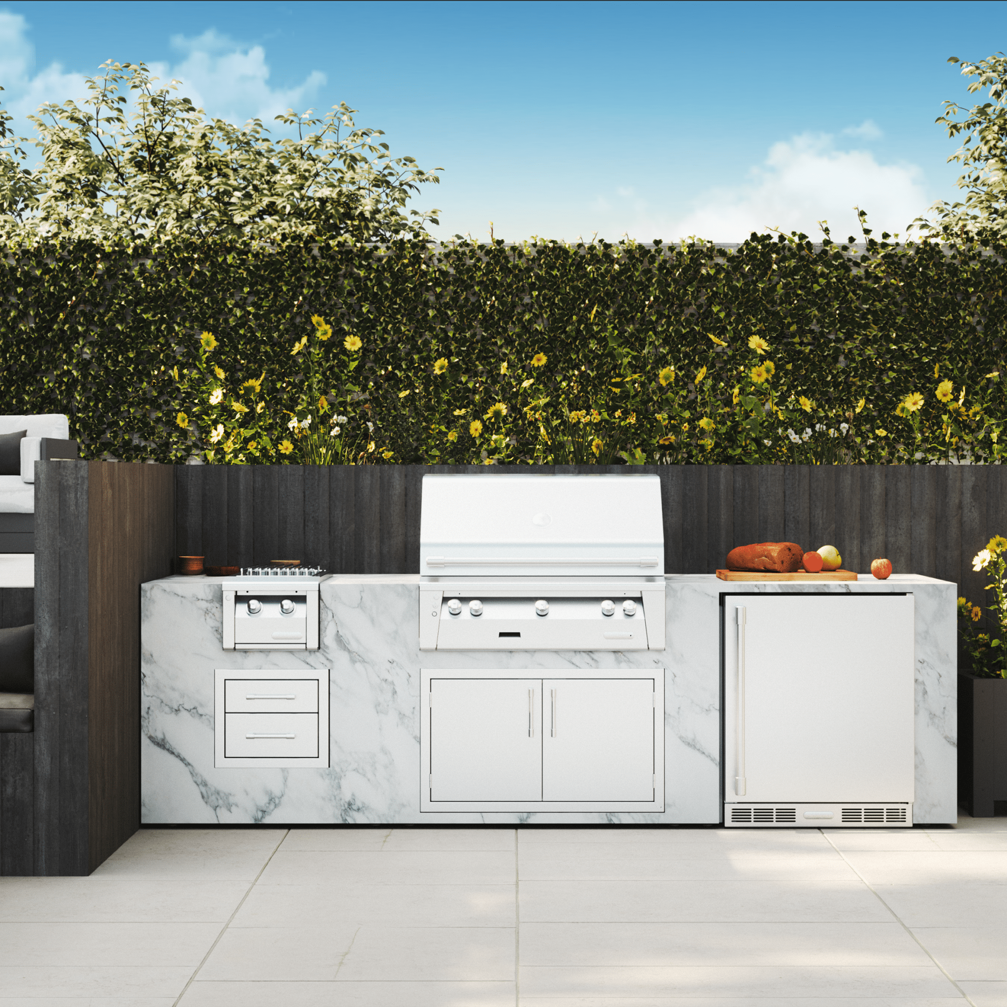 Outdoor kitchen with marble countertops and stainless steel appliances in a garden setting.